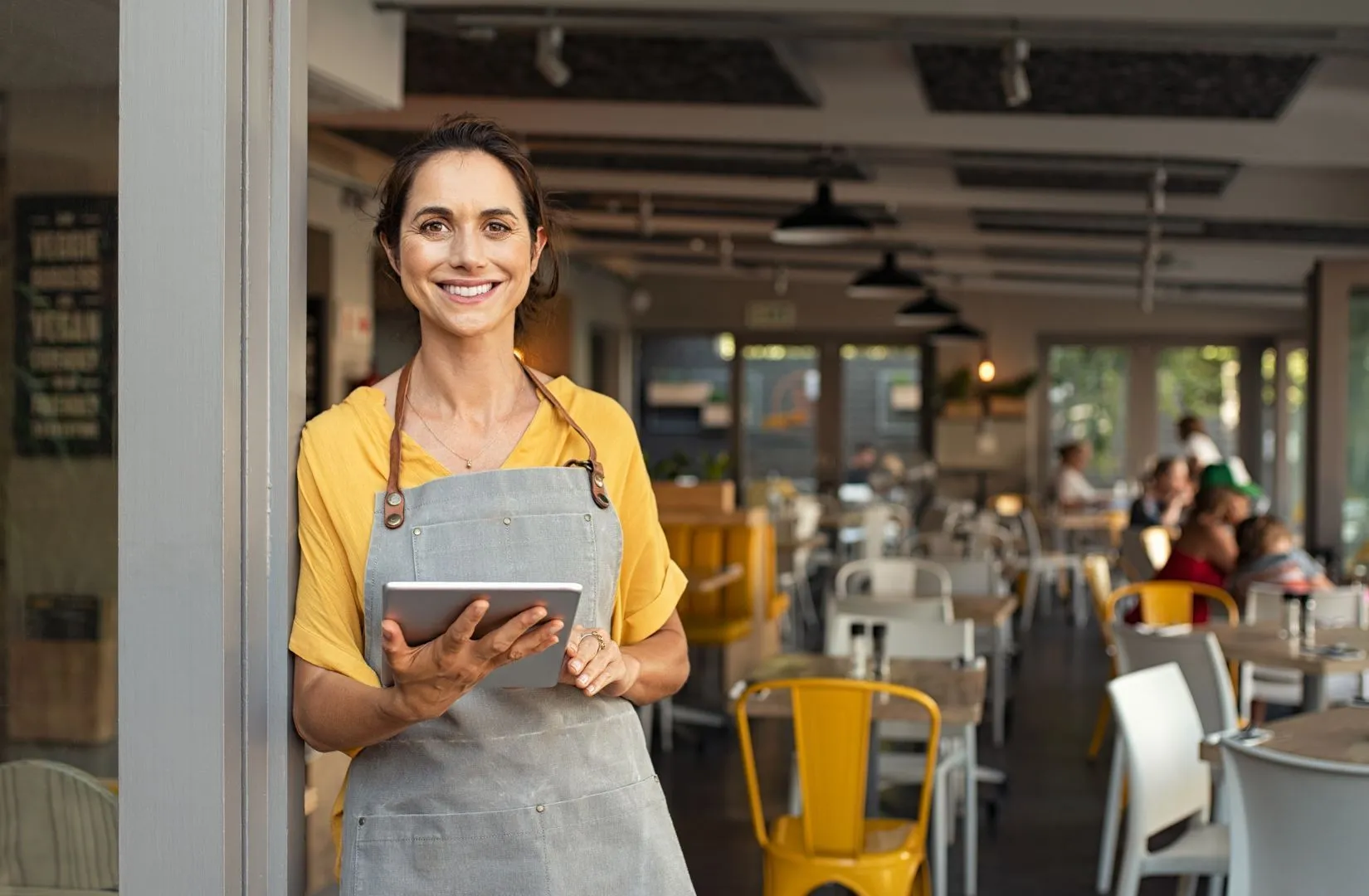 Small-business owner using a tablet inside a local storefront